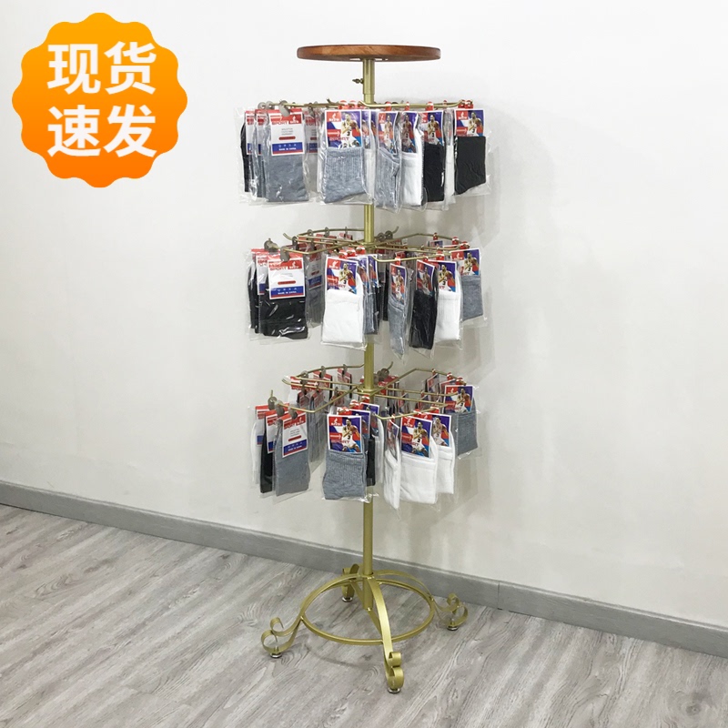 The shelves with socks show the shelves of the floor-to-ceiling multi-purpose supermarket store round rotating glove mask hangers